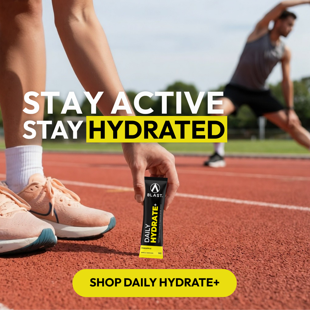 Person holding a Daily Hydrate supplement on a running track with text 'Stay Active, Stay Hydrated'.