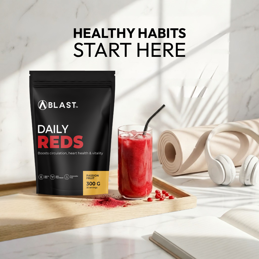 Blast Daily Reds supplement package with a red smoothie on a wooden tray.