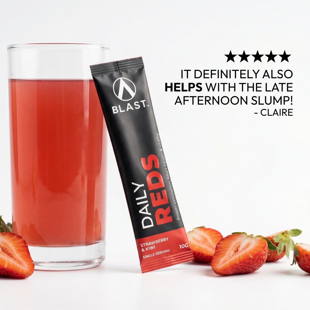 Blast Daily Reds supplement package with a glass of red liquid and strawberries on a white background.