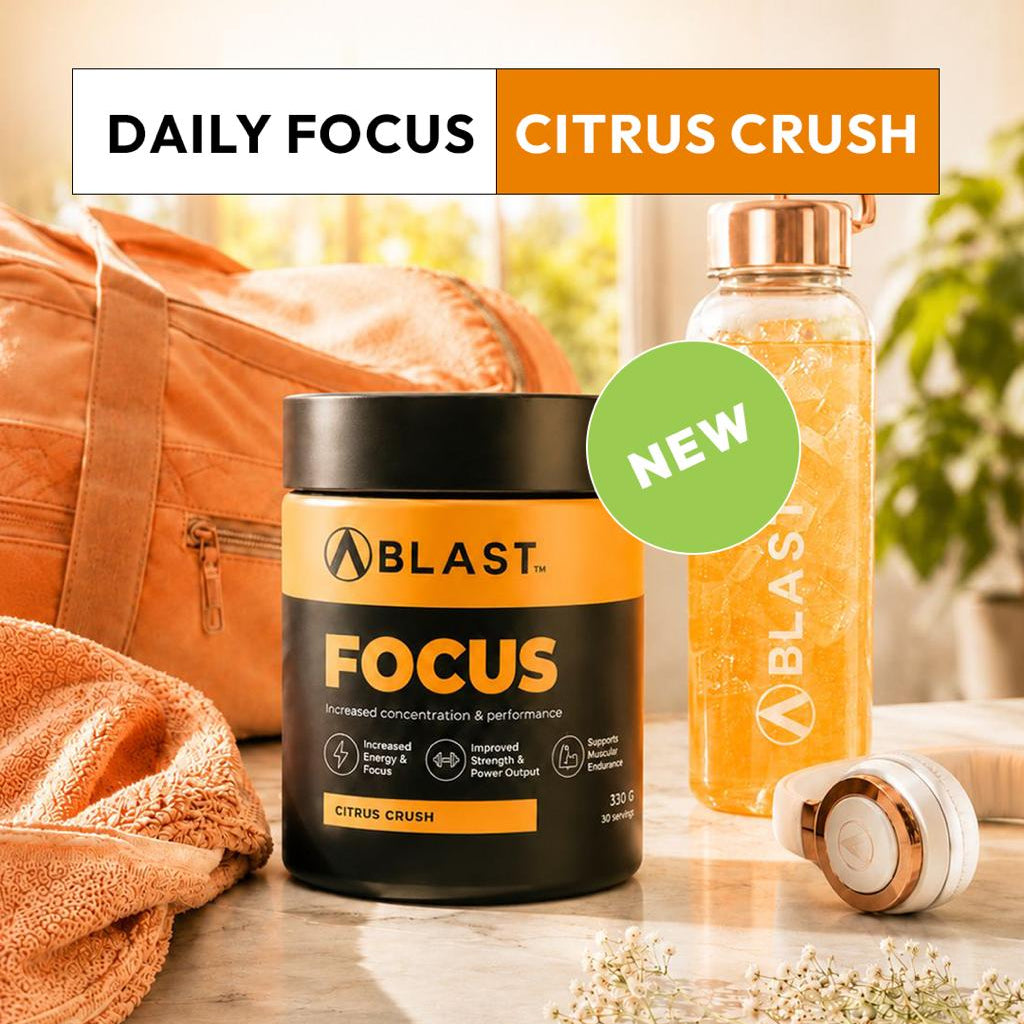Blast Focus supplement container with a bottle and towel on a wooden surface