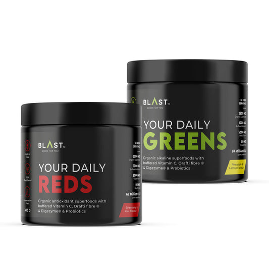 Two supplement powder containers labeled ’Your Daily Reds’ and ’Your Daily Greens’ from BLAST.