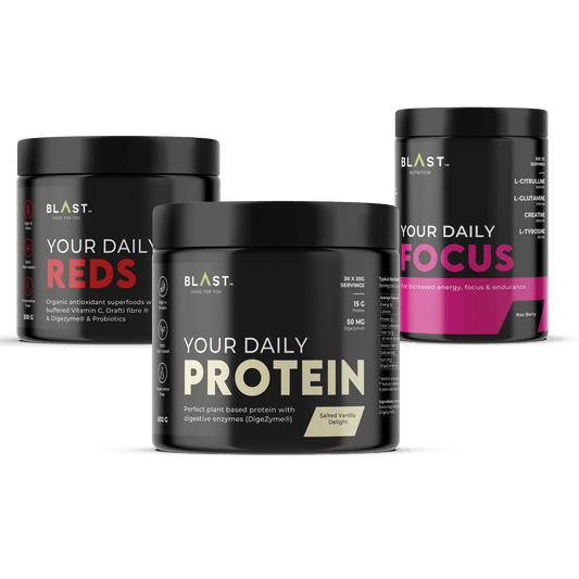 Three black supplement containers labeled ’Your Daily Reds,’ ’Your Daily Protein,’ and ’Your Daily Focus.’